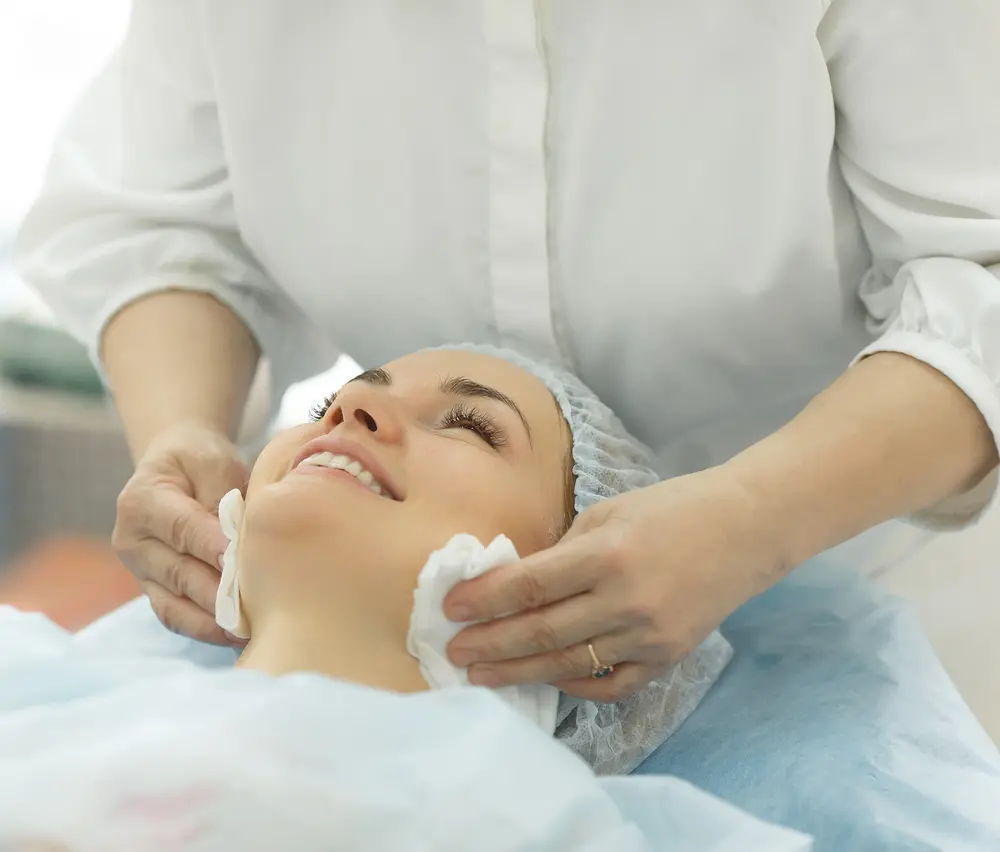 Beautician prepping face